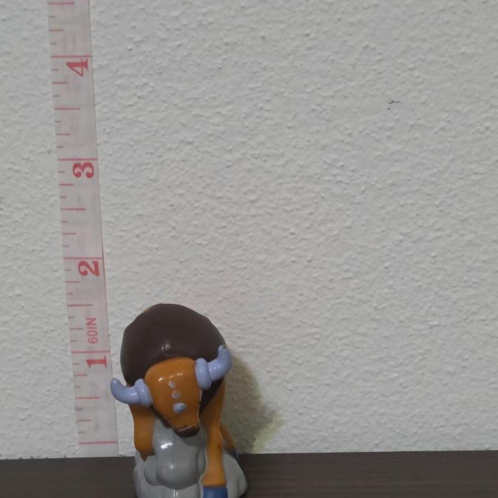 burgerking pokemon tauros figurine with brown and orange body, blue hooves, and